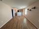 Upstairs hallway with beautiful hardwood floors and neutral walls, connecting various rooms at 228 Star Shell Dr, Apollo Beach, FL 33572