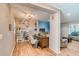 Well-lit home office featuring hardwood floors, built-in shelving, and a comfortable work space at 228 Star Shell Dr, Apollo Beach, FL 33572