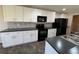 Updated kitchen features white cabinets, black appliances, and modern backsplash at 228 Star Shell Dr, Apollo Beach, FL 33572