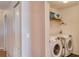 This laundry room includes laundry machines and storage on the walls at 228 Star Shell Dr, Apollo Beach, FL 33572