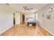 Spacious primary bedroom with hardwood floors, ceiling fan, and an adjacent walk-in closet at 228 Star Shell Dr, Apollo Beach, FL 33572