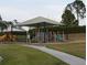 Inviting neighborhood playground with climbing structure, slides and covered areas at 228 Star Shell Dr, Apollo Beach, FL 33572
