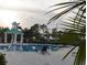 Relaxing poolside view with a gazebo, lounge chair, and palm trees at 228 Star Shell Dr, Apollo Beach, FL 33572