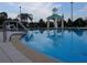 Community pool area featuring a large pool, gazebo, lounge chairs, and palm trees at 228 Star Shell Dr, Apollo Beach, FL 33572