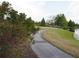 Scenic walking path along the community lake and green spaces, perfect for outdoor enjoyment and recreation at 228 Star Shell Dr, Apollo Beach, FL 33572