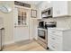 Modern kitchen with white cabinets and stainless steel appliances at 2866 15Th N Ave, St Petersburg, FL 33713