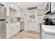 Updated kitchen with white cabinets, quartz countertops, and stainless steel appliances at 2866 15Th N Ave, St Petersburg, FL 33713