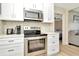 Updated kitchen with stainless steel appliances and white cabinets at 2866 15Th N Ave, St Petersburg, FL 33713
