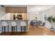 Open dining area features modern lighting, bar stool seating, hardwood floors, and neutral paint at 5306 Santa Rosa Ct # 342, Tampa, FL 33609
