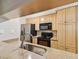 Modern kitchen featuring stainless steel appliances and light wood cabinets at 5306 Santa Rosa Ct # 342, Tampa, FL 33609