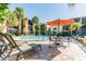 Relaxing pool area with lounge chairs and patio umbrella at 5306 Santa Rosa Ct # 342, Tampa, FL 33609