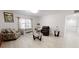 Bright living room with light tile floors and comfy seating at 17130 Pasco Acres Dr, Spring Hill, FL 34610