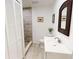 Updated bathroom with a walk-in shower and white vanity at 17130 Pasco Acres Dr, Spring Hill, FL 34610