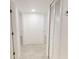 Clean and bright hallway with tile flooring and built-in storage at 17130 Pasco Acres Dr, Spring Hill, FL 34610