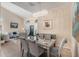 Open concept dining room with a mirrored table and comfortable seating for six at 11140 Oyster Bay Cir, New Port Richey, FL 34654
