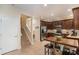 Well-equipped kitchen featuring dark wood cabinets and a breakfast bar at 11140 Oyster Bay Cir, New Port Richey, FL 34654