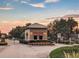 Gated community entrance with guardhouse at sunset at 11140 Oyster Bay Cir, New Port Richey, FL 34654
