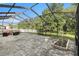 Peaceful screened patio with garden area and tranquil backyard views at 11140 Oyster Bay Cir, New Port Richey, FL 34654