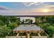 Community pool and clubhouse with scenic lake view at sunset at 11140 Oyster Bay Cir, New Port Richey, FL 34654