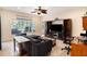 Gathering room with comfortable seating, large screen TV, and home office space at 11140 Oyster Bay Cir, New Port Richey, FL 34654