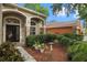 Front entrance with dark brown door and manicured landscaping at 11140 Oyster Bay Cir, New Port Richey, FL 34654