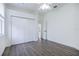 Spacious bedroom with wood-look floors, double door closet, and access to hallway at 6120 Cezanne Ave, Lutz, FL 33558