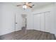 Bright bedroom with wood-look floors, double door closet, and access to another room at 6120 Cezanne Ave, Lutz, FL 33558