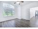 Spacious bedroom featuring wood-look floors and an open door to hallway at 6120 Cezanne Ave, Lutz, FL 33558