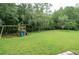 Large backyard with playset and ample green space at 6120 Cezanne Ave, Lutz, FL 33558