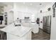 Modern kitchen featuring white cabinets, marble countertops, and stainless steel appliances at 6120 Cezanne Ave, Lutz, FL 33558