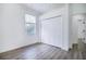 Bright bedroom with wood-look floors, window, and built-in closet at 6120 Cezanne Ave, Lutz, FL 33558