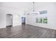 Bright dining room with hardwood floors and elegant chandelier at 6120 Cezanne Ave, Lutz, FL 33558