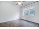 Well-lit bedroom with wood-look floors and a window with blinds at 6120 Cezanne Ave, Lutz, FL 33558