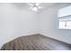 Well-lit bedroom, featuring wood-look floors and a window with blinds at 6120 Cezanne Ave, Lutz, FL 33558