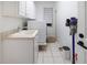 Bright laundry room with washer, dryer, and utility sink at 6120 Cezanne Ave, Lutz, FL 33558