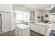 Open concept kitchen with island, white cabinets and marble countertops at 6120 Cezanne Ave, Lutz, FL 33558