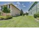 Side yard with landscaping and black fence at 228 Star Shell Dr, Apollo Beach, FL 33572