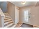Inviting entryway with staircase, storage closet, and a charming front door with glass panes at 228 Star Shell Dr, Apollo Beach, FL 33572