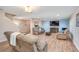 Spacious living room featuring hardwood floors, comfortable recliners, and a large TV at 228 Star Shell Dr, Apollo Beach, FL 33572