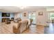 Bright living room with hardwood floors, access to backyard, and neutral color palette at 228 Star Shell Dr, Apollo Beach, FL 33572
