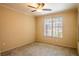 Spacious bedroom with ceiling fan, large window, and carpet flooring at 4221 W Spruce St # 1310, Tampa, FL 33607