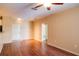 Bright living room with hardwood floors, ceiling fan, and access to other rooms at 4221 W Spruce St # 1310, Tampa, FL 33607