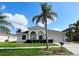 House exterior with palm trees and a landscaped front yard at 12009 Pennfield Pl, Riverview, FL 33579