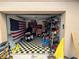 Garage with checkered floor, shelving, and American flag at 6297 Harcross Ct, Spring Hill, FL 34606