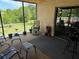Relaxing screened porch with patio furniture and view of backyard at 6297 Harcross Ct, Spring Hill, FL 34606