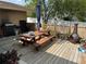 Wooden deck with picnic table, grill, and fire pit at 6297 Harcross Ct, Spring Hill, FL 34606