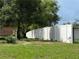 Side yard with white vinyl fence and landscaping at 6297 Harcross Ct, Spring Hill, FL 34606
