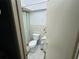 Small bathroom with a toilet, shower, and a patterned shower curtain at 6297 Harcross Ct, Spring Hill, FL 34606