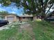 House exterior showcasing a ranch-style home with a yard and driveway at 6297 Harcross Ct, Spring Hill, FL 34606