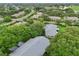 Overhead shot showing home's layout within a verdant, tree-lined neighborhood, complemented by paved streets at 1606 Laughton Pl, Sun City Center, FL 33573